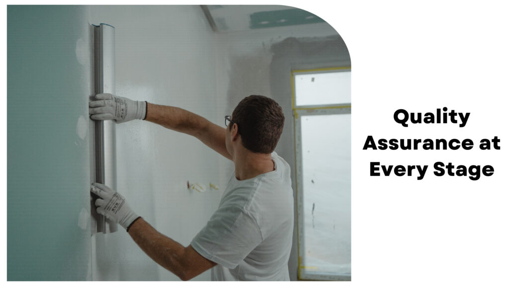 A person in a white shirt and gloves is smoothing a green wall with a metal tool. Text reads "Quality Assurance at Every Stage." Residential construction services, especially those provided by house construction companies in Bangalore, ensure meticulous attention to detail.