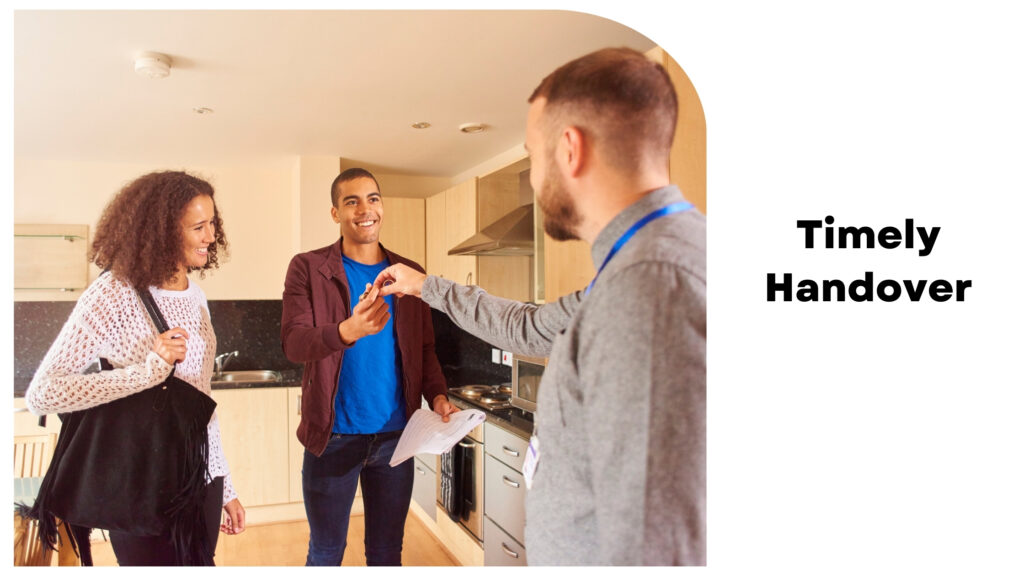 A person hands over keys to a smiling man and woman standing in a kitchen, captioned "Timely Handover." This is the hallmark of top-tier house construction companies in Bangalore.